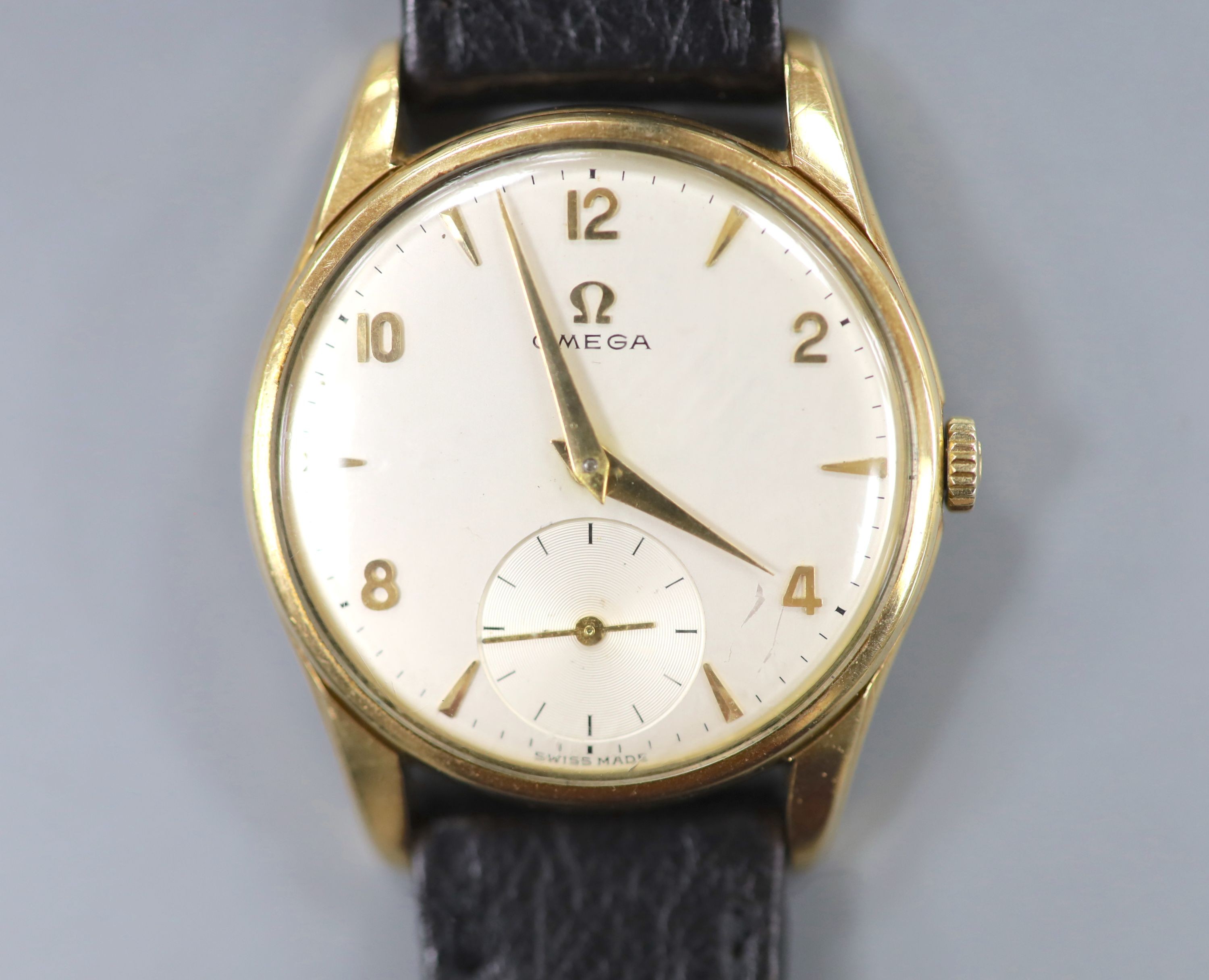 A gentleman's 9ct gold Omega manual wind wrist watch, on associated leather strap, with case back inscription, case diameter 33mm, gross weight 35.1 grams.